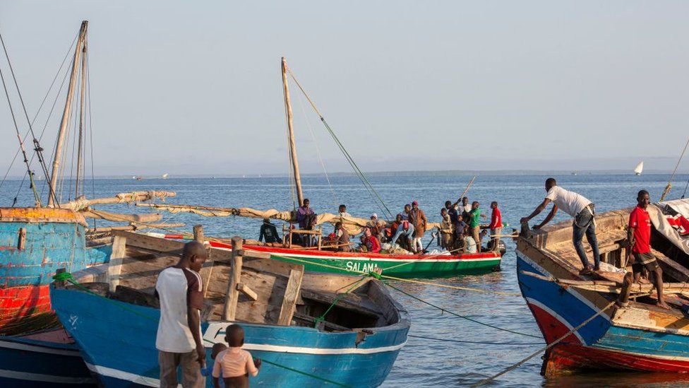 Fishermen tend to their boats on the shores of the Paquitequete neighborhood in Pemba.