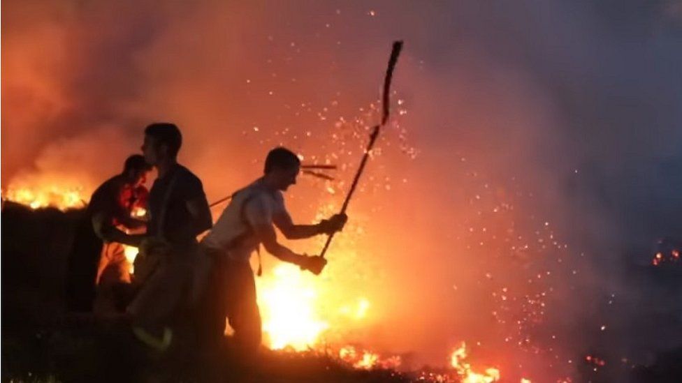 Firefighters try to quell the fire