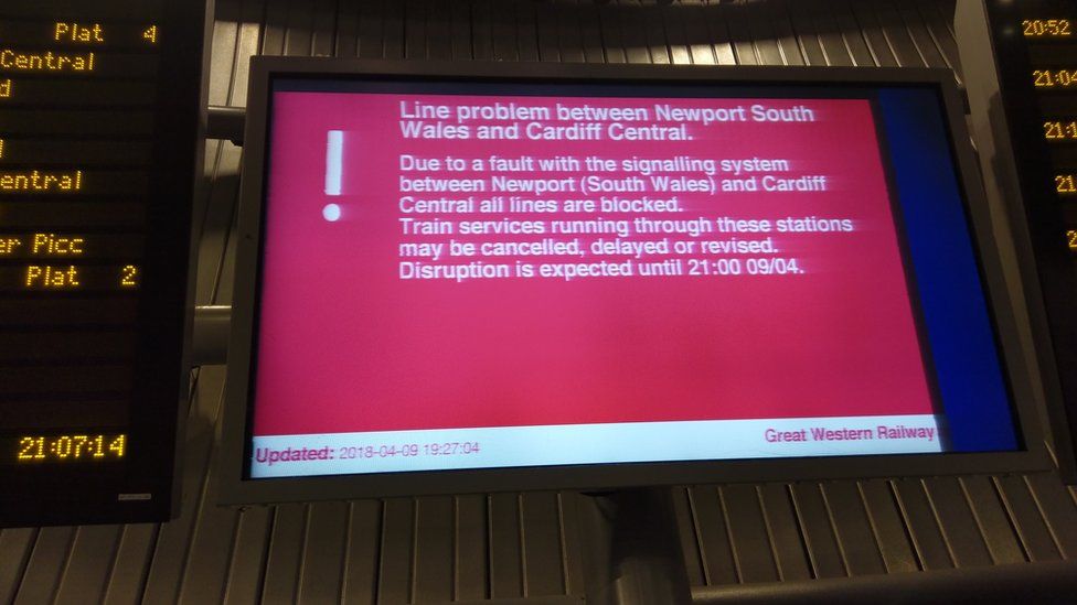 A rail station sign warning of delays
