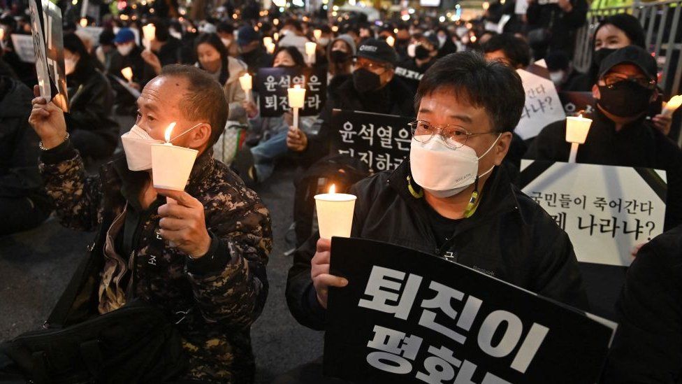 People take part in a candlelight vigil to commemorate the 156 people killed in the October 29 Halloween crowd crush, in Seoul on November 5, 2022