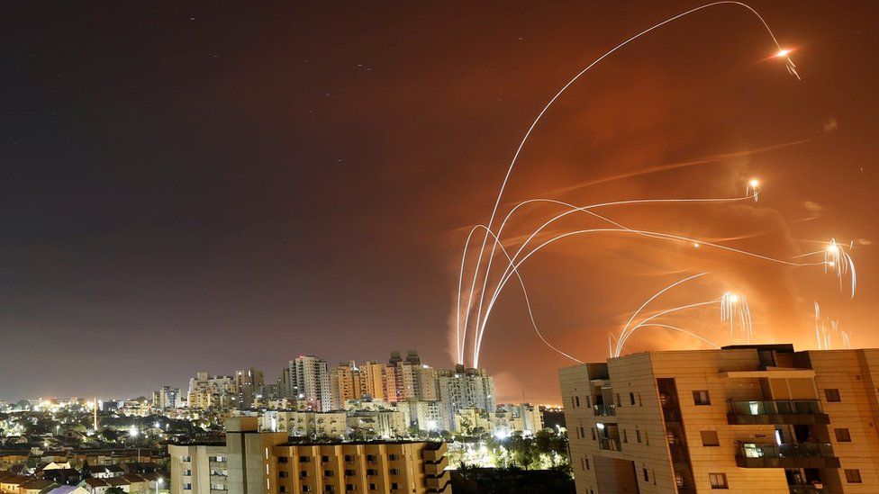 Streaks of light are seen as Israel's Iron Dome anti-missile system intercepts rockets launched from the Gaza Strip towards Israel, as seen from Ashkelon, Israel (12 May 2021)