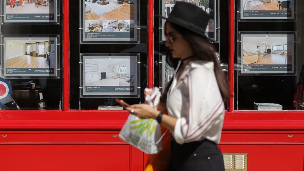 Woman in front of an estate agent