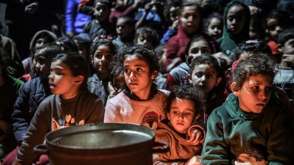 Palestinians, who have to flee their homes to ensure their safety from the Israeli attacks and take refuge in a school, gather to celebrate Lailat al Miraj in Rafah, Gaza on February 8, 2024