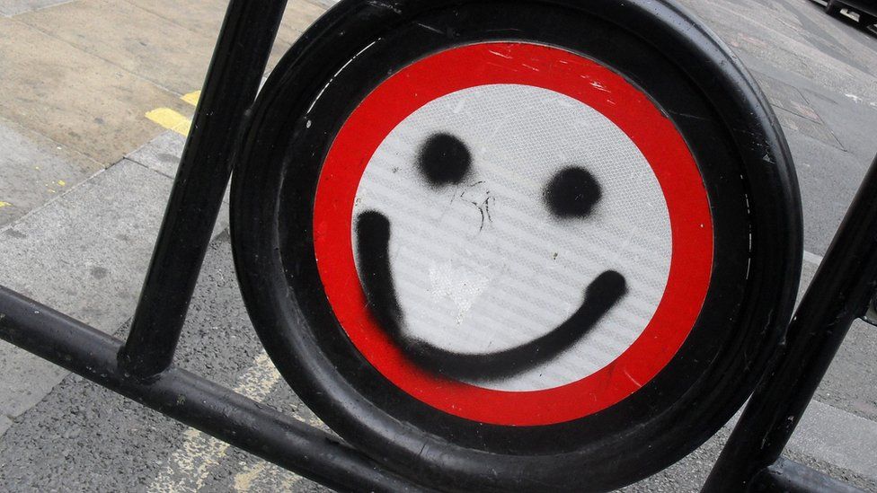 smiley face painted on sign