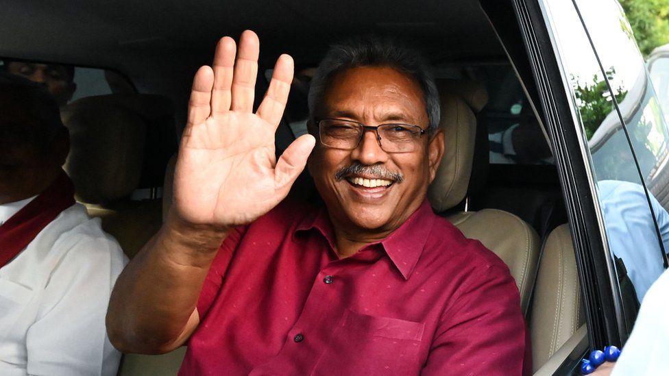 Gotabaya Rajapaksa waving to supporters out of a car window after his election victory was announced