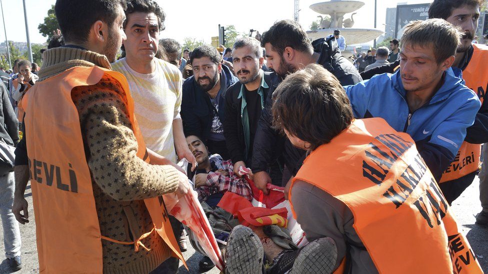 People helping someone wounded in explosions in Ankara, Turkey, Saturday 10 October 2015