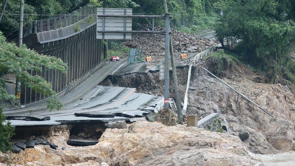 A road is destroyed following torrential rain near the Kuma river in Ashikita, Kumamoto prefecture, on July 6, 2020