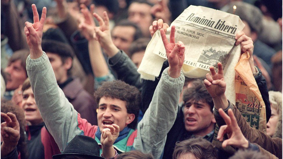Romanians celebrate the fall of the Ceausescu regime in December 1989