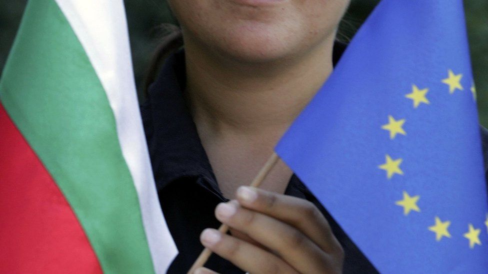 File image of woman holding a Bulgarian flag and an EU flag