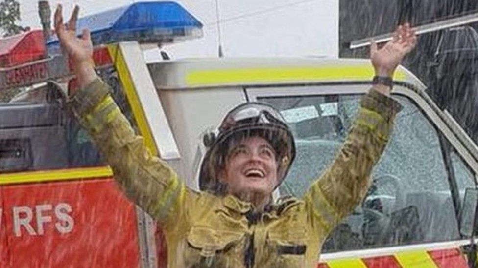 Fire crew in Australia celebrate the arrival of rain