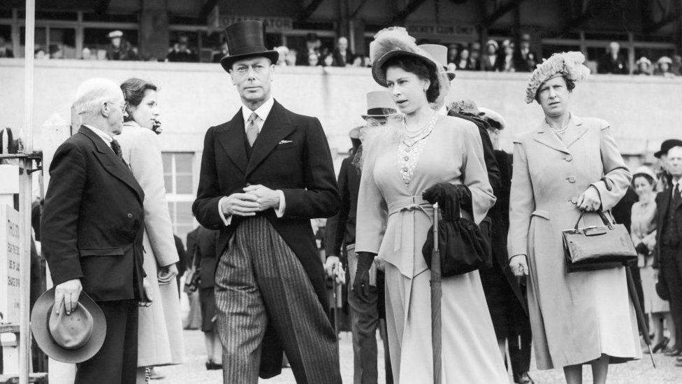 A black and white photo of Princess Elizabeth with her father King George VI
