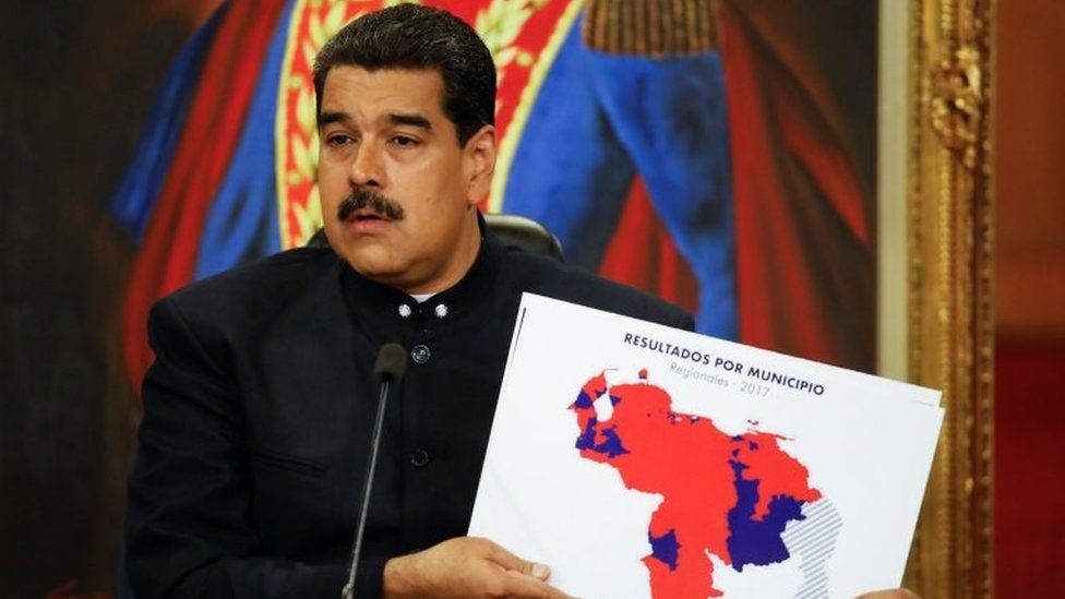 Venezuela's President Nicolas Maduro holds a map of Venezuela during a news conference at Miraflores Palace in Caracas, Venezuela October 17, 2017.