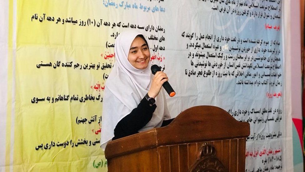 Student Fatemeh Amiri speaks to a podium