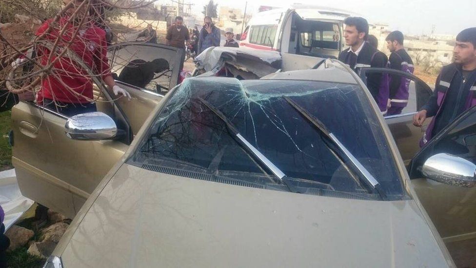 Car with roof shattered is shown in photo taken from Syrian opposition activists Local Co-ordination Committees' Facebook page