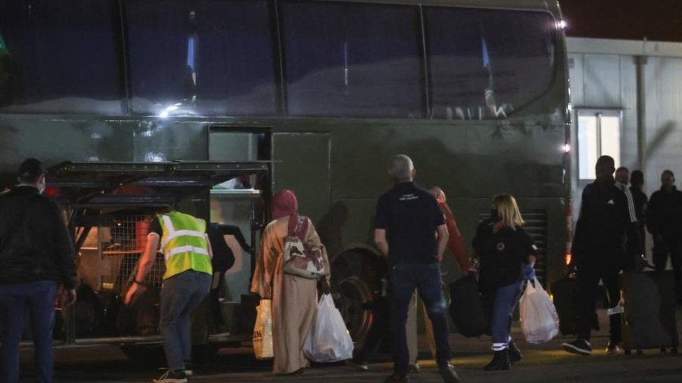 People getting on a bus at a Cyprus airport