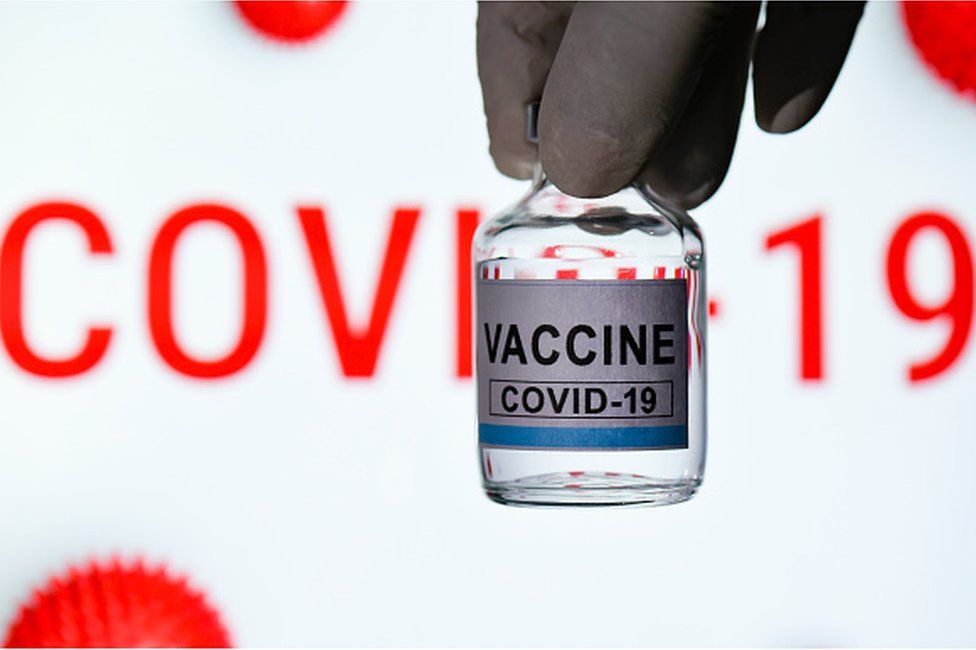 In this photo illustration a doctor holds a bottle labelled as the Covid-19 coronavirus vaccine in Guwahati, India on 28 November 2020