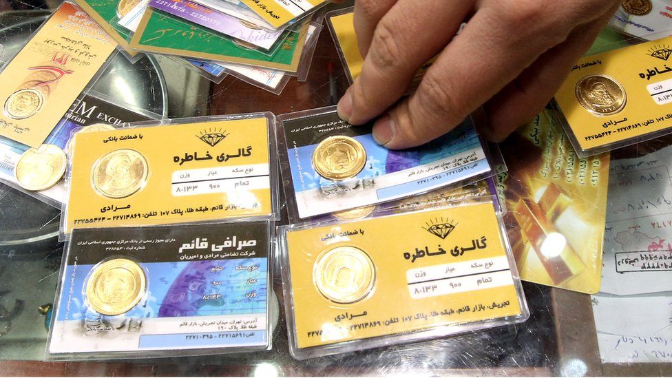 Gold coins are exchanged in Tehran as the Iranian currency, the rial, continues to lose value against the US dollar, 23 January 2012