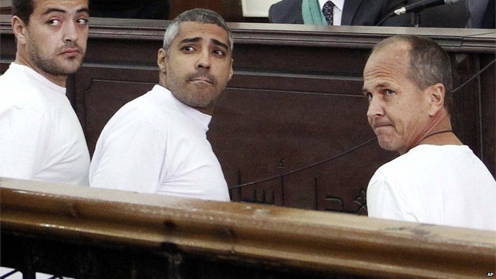 Al-Jazeera journalists Baher Mohamed, Mohammed Fahmy, and Peter Greste (R) in court in Egypt, March 2014