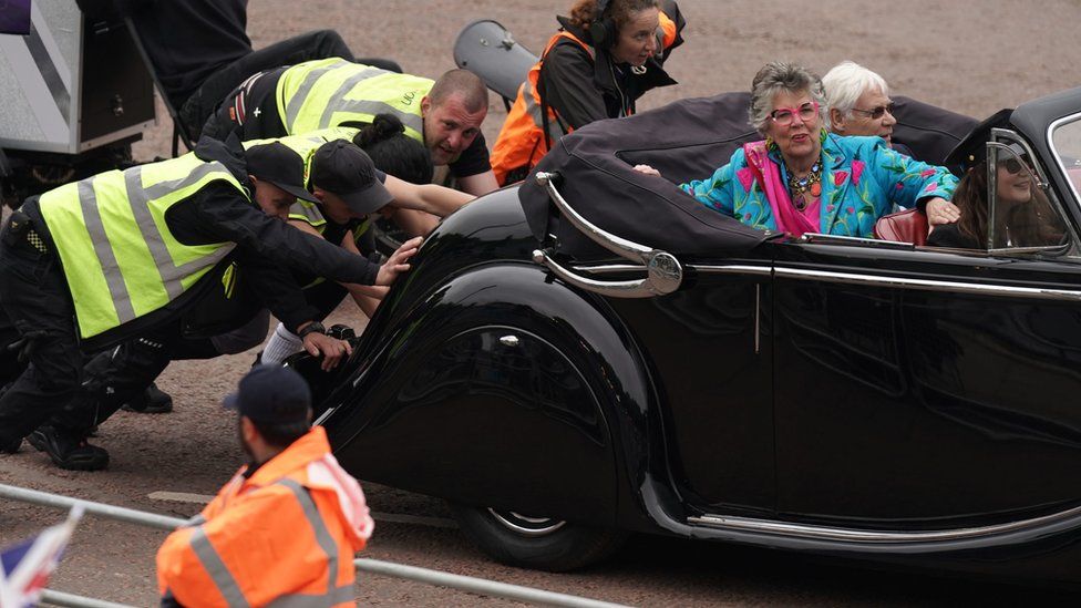 The car carrying Bake Off judge Prue Leith is pushed after it broke down during the Platinum Jubilee Pageant in front of Buckingham Palace
