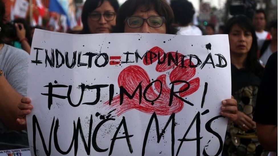 A protester holds a sign reading: "Pardon equal impunity. Fujimori no more" during a march against former president Alberto Fujimori"s pardon in Lima, Peru, January 11, 2018.