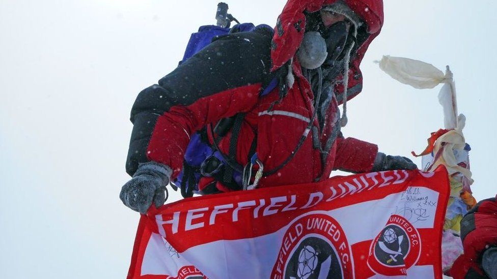 Ian Toothill with Sheffield United FC flag on Mount Everest