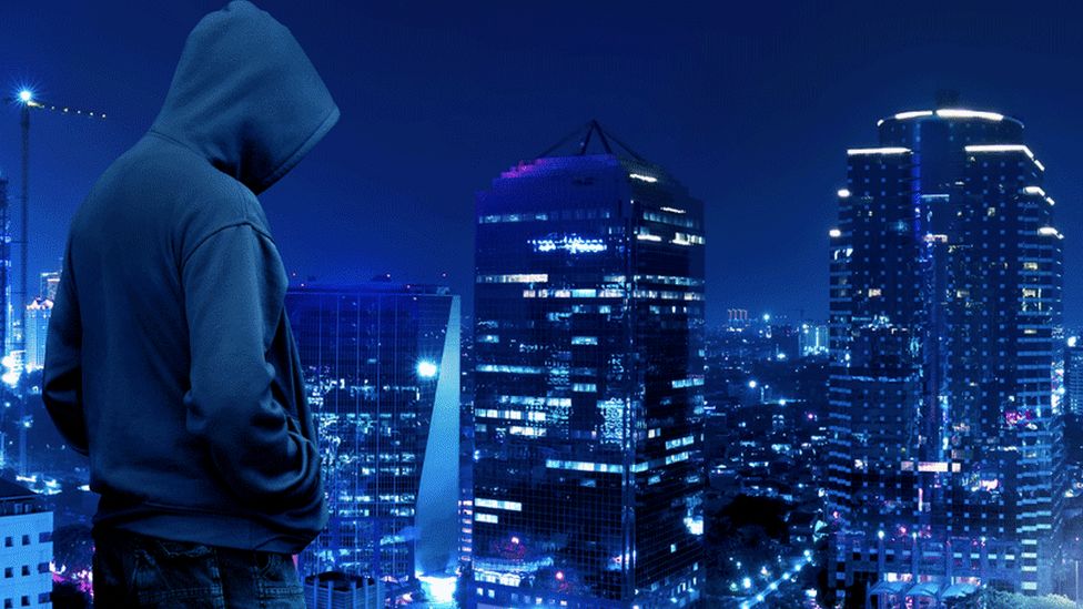 Man in hooded top looking over city