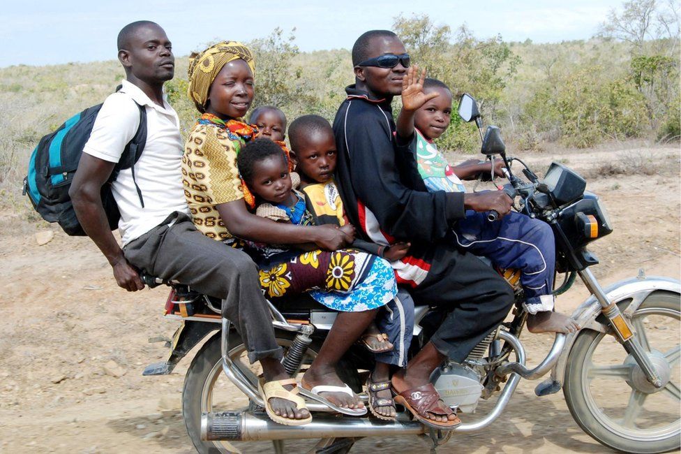 A boda boda operator transports a family of six on his bike in Kwale County, Kenya.