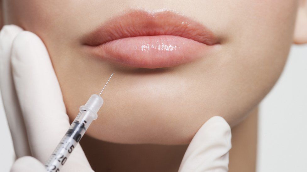 Botox being injected in a woman's lip