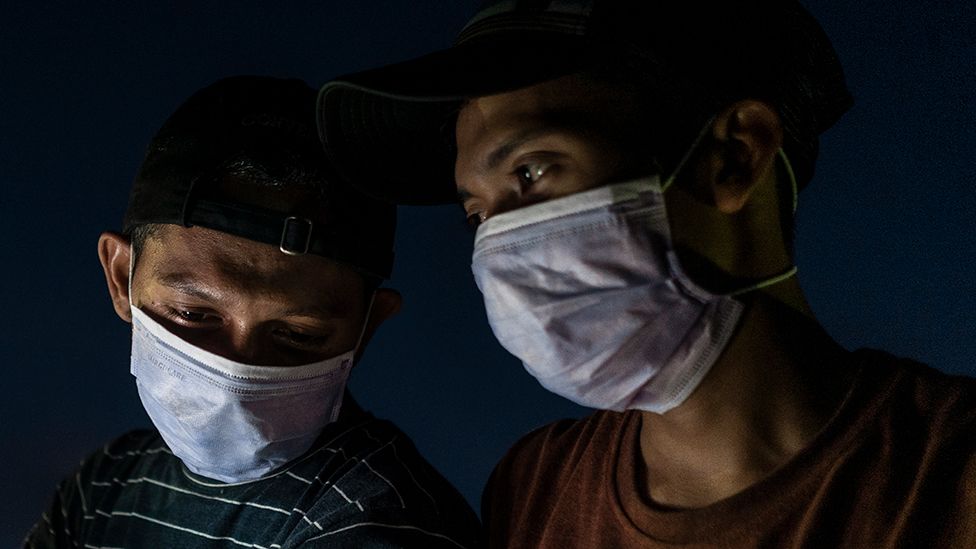 Two men wearing masks in Aceh