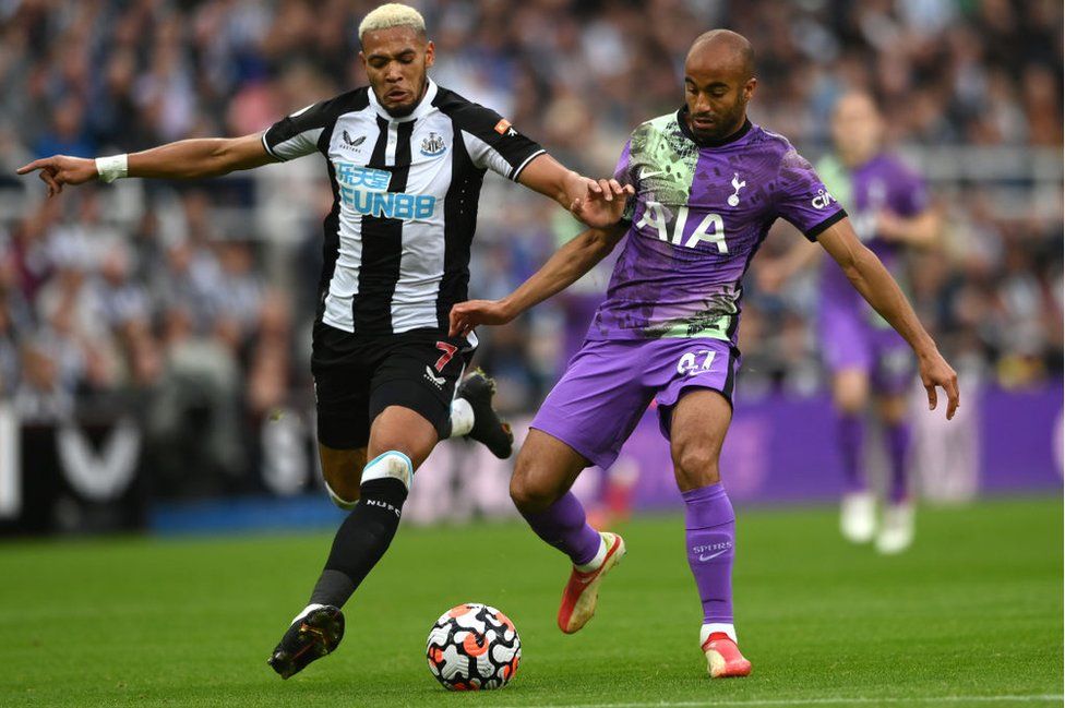Joelinton of Newcastle and Lucas Moura of Spurs compete for the ball