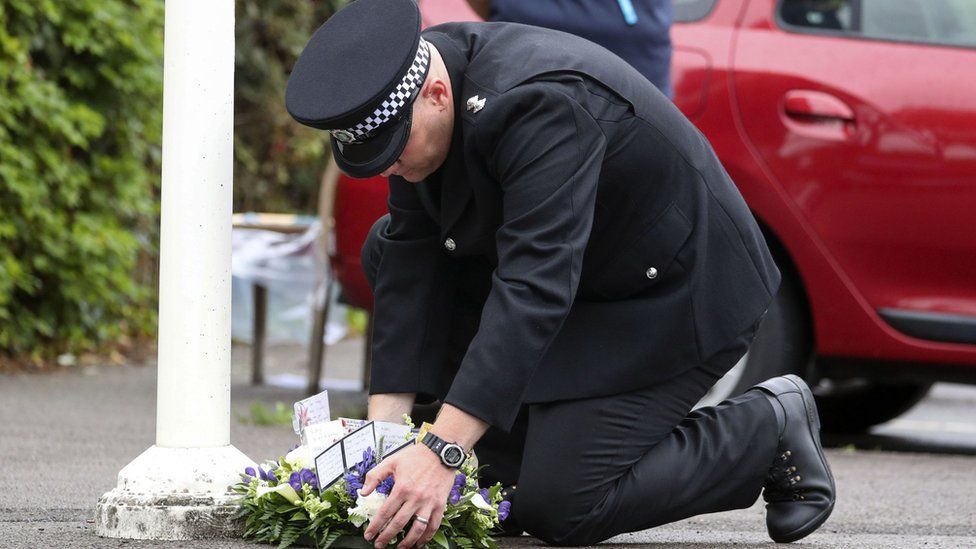 Officer laying wreath