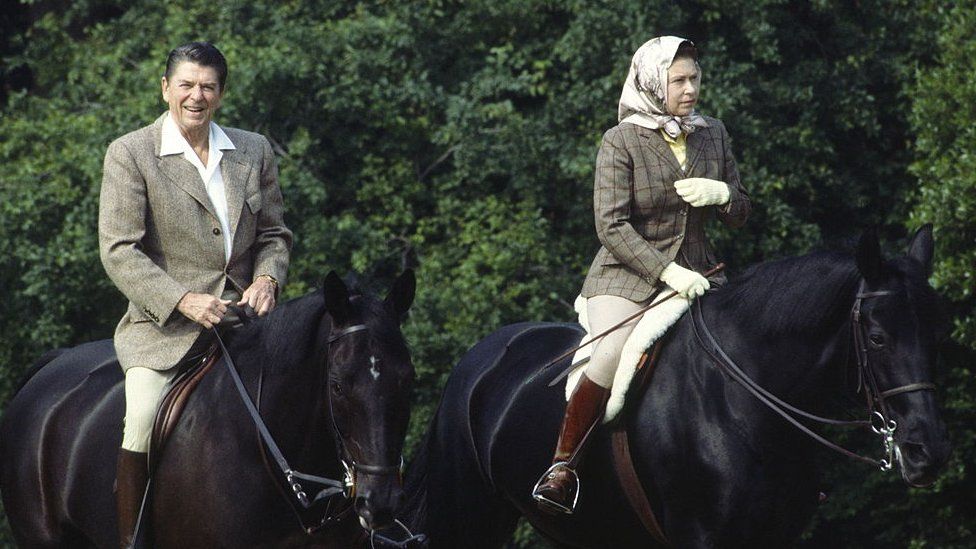 Ronald Reagan riding with the Queen