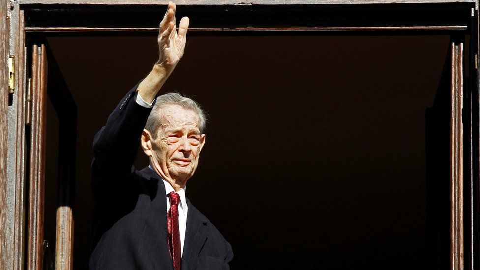 Romania's former King Michael waves during a ceremony celebrating both his 92nd birthday in 2013