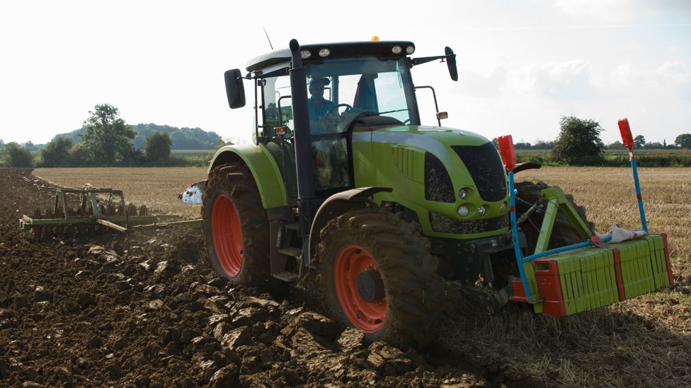 Stock image of a tractor working in a field