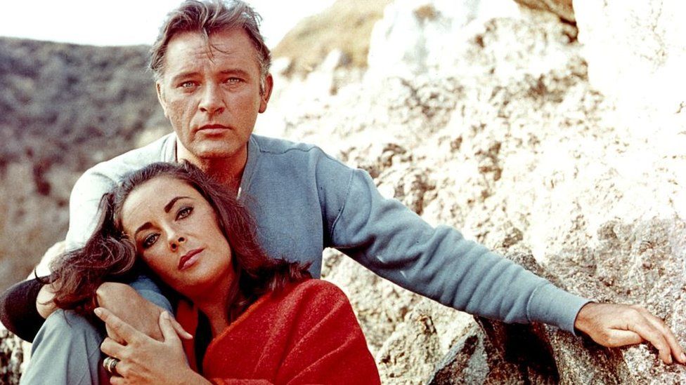 Elizabeth Taylor and Richard Burton on the film set of "The Sandpiper" in 1965.