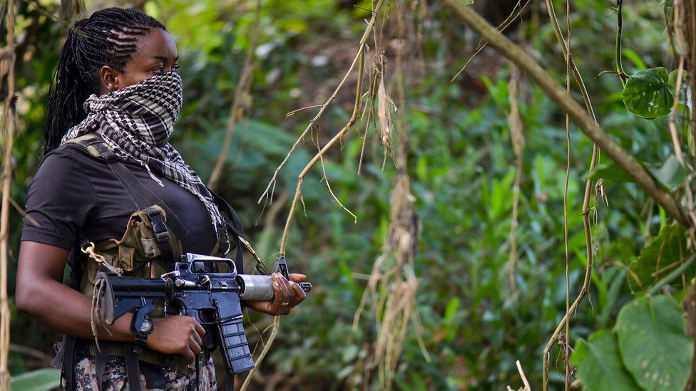 This photo taken on January 26, 2017 shows a ELN member guarding the area as AFP conducts an interview in Alto Baudo
