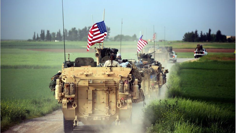 US forces, accompanied by Kurdish People's Protection Units (YPG) fighters, drive their armoured vehicles near the northern Syrian village of Darbasiyah, on the border with Turkey on April 28, 2017