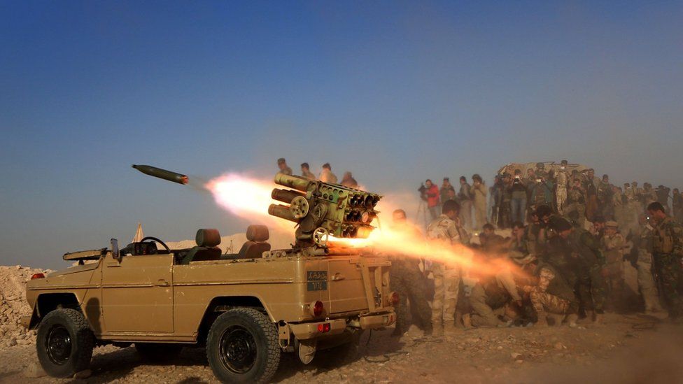 Iraqi Kurdish fighters fire a multiple rocket launcher from a position near the town of Bashiqa, some 25km north-east of Mosul, on 20 October 2016