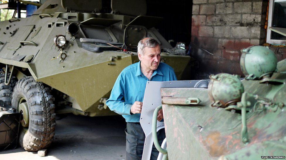 Man repairing armoured personnel carrier