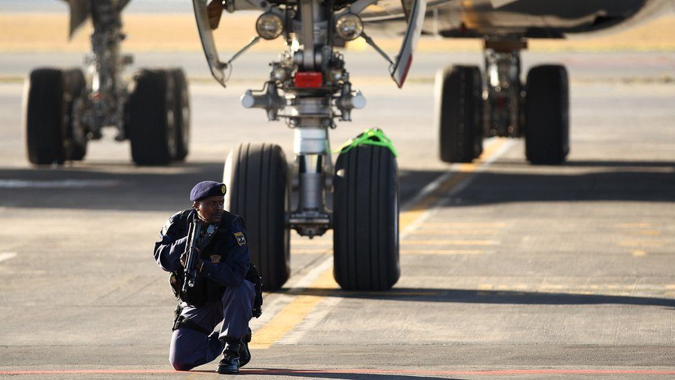 Armed Police officers guard the plane before the players disembark as the England team arrive at Johannesburg's O.R. Tambo International Airport for the 2010 FIFA World Cup on June 3, 2010 in Johannesburg, South Africa.