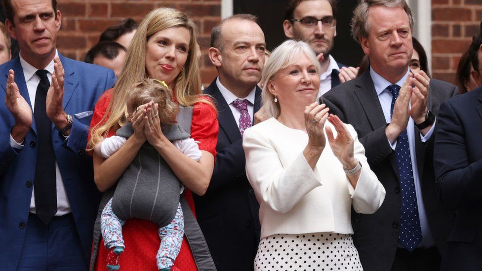 Carrie Johnson, her baby Romy, and Nadine Dorries MP in the crowd