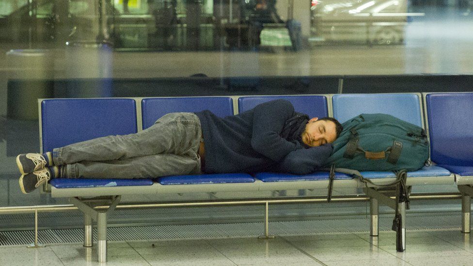 A man asleep at Heathrow Airport
