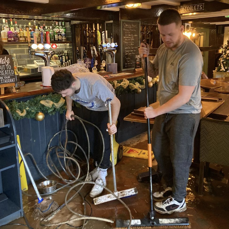 Men working to clean the pub
