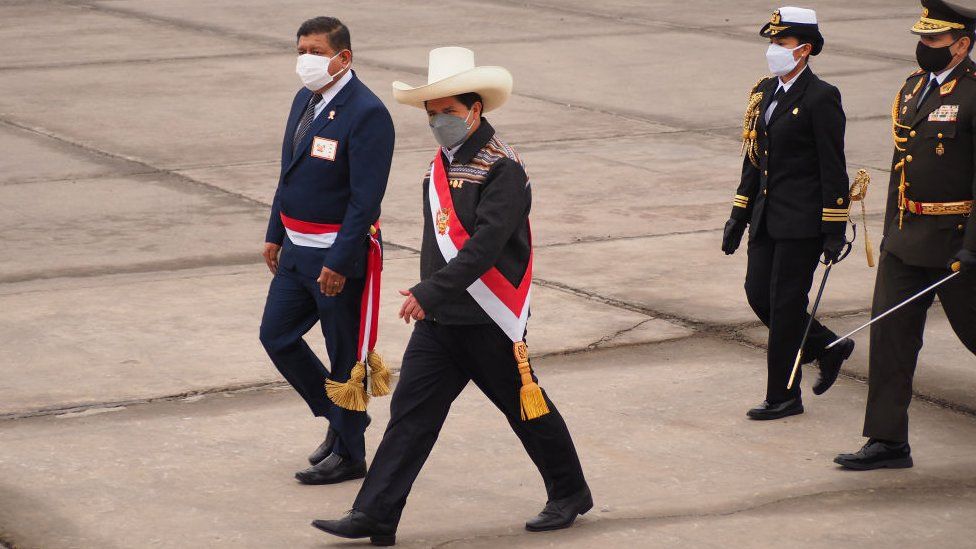 Peruvian President Pedro Castillo (white hat) reviewing the troops at military parade commemorating 200th anniversary of Peruvian independence.