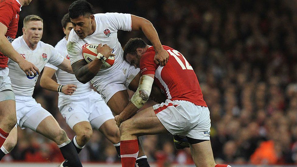 Wales' Jamie Roberts Tackles England's Manu Tuilagi at an international rugby union match