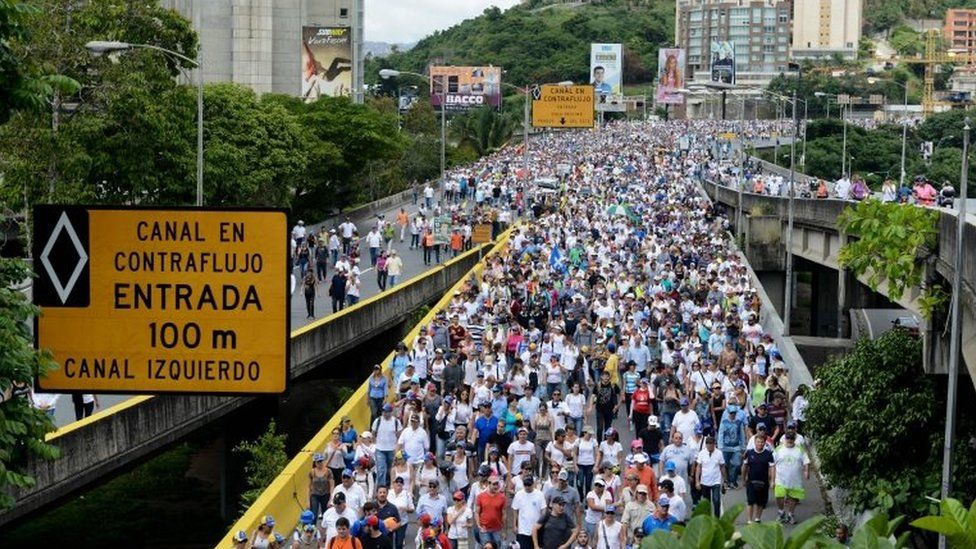 Opposition activists protest against the government of President Nicolas Maduro along the Francisco Fajardo highway in Caracas on June 19, 2017.
