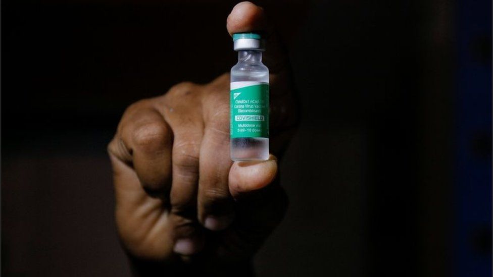 A hand holds a vial of AstraZeneca's COVISHIELD vaccine as the country receives its first batch of coronavirus disease (COVID-19) vaccines under COVAX scheme, in Accra, Ghana February 24, 2021