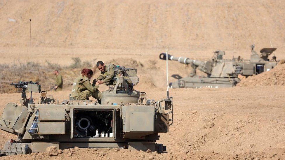 sraeli soldiers with armoured fighting vehicles at an area along the border with Gaza