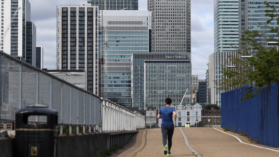 A jogger runs through a quiet Canary Wharf