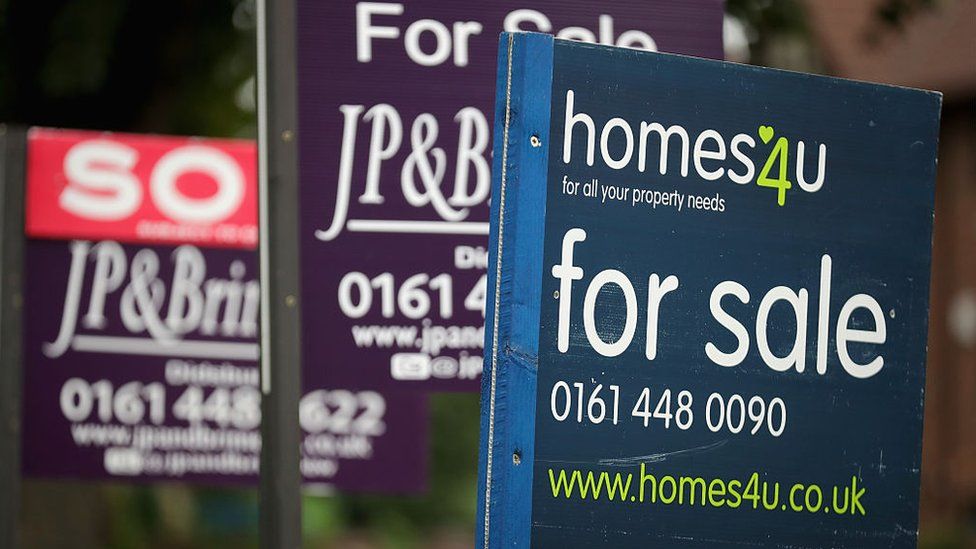 For Sale boards stand outside homes in Didsbury on August 2, 2016 in Manchester